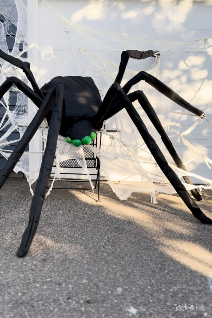 Close-up of giant DIY spider legs made from chicken wire and landscape fabric