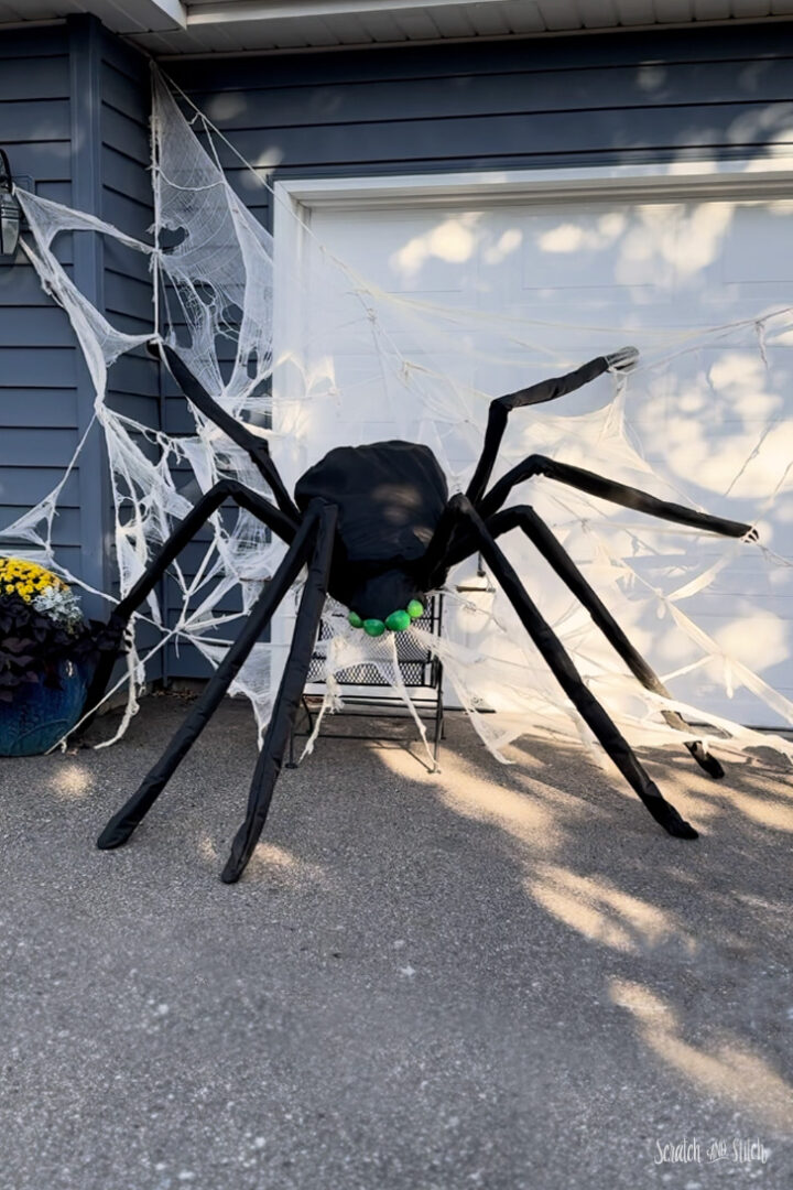 DIY giant Halloween spider decoration made with chicken wire and cheesecloth