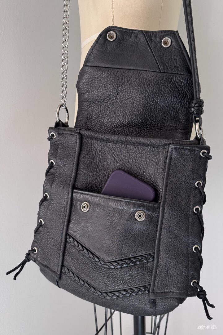 Custom leather crossbody bag made from a biker vest with a personal shirt lining inside