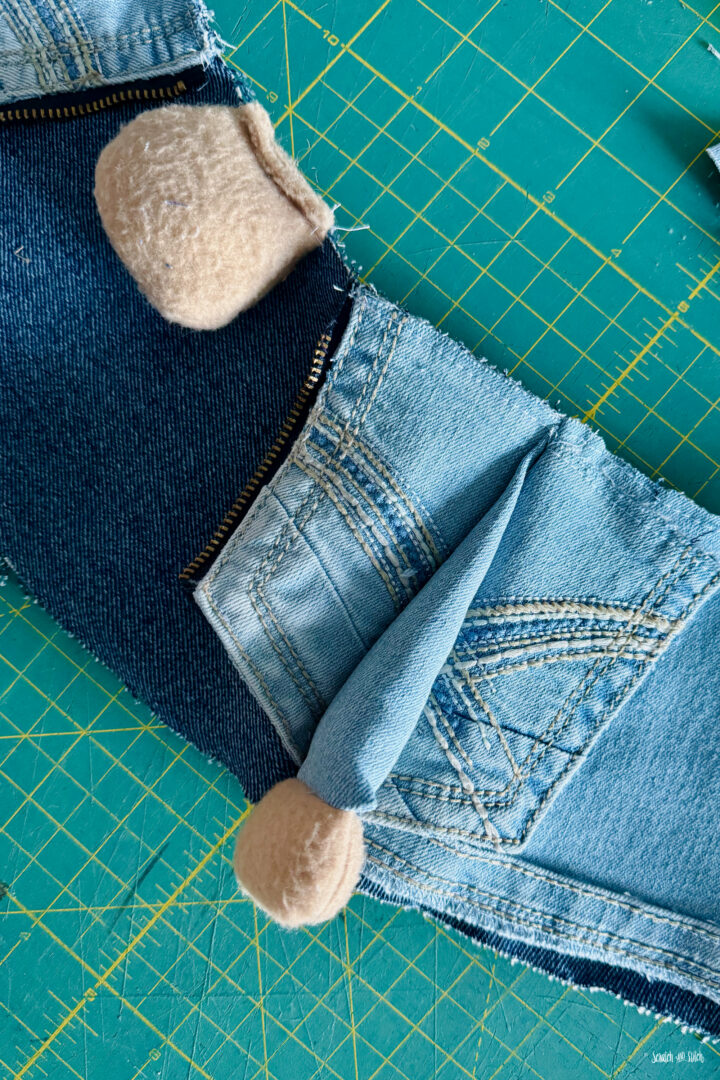 miniature denim jean jack for a plush gnome on a cutting table